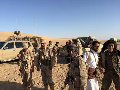 A group of soldiers trained by Emirati and Gulf Arab forces gather with Yemeni tribesmen gather near a military base in Marib province. Noah Browning / Reuters