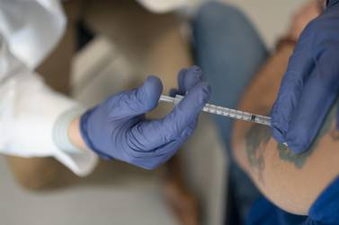 A pharmacist administers a dose of the Covid-19 vaccine in Arkansas City, Kansas, March 5, 2021. Bloomberg