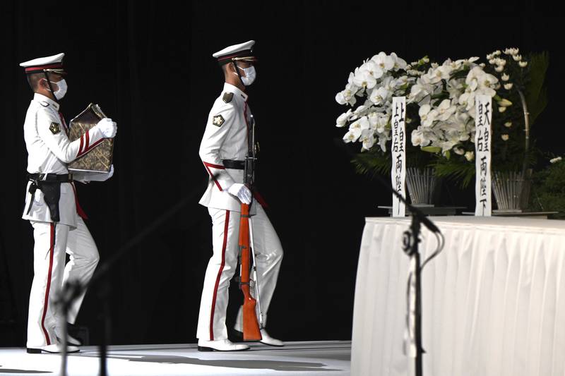 Members of an honour guard carry Abe's ashes during his funeral. Abe was delivering a speech near a train station in the western city of Nara when he was shot dead by an assailant on July 8. It was the first assassination of a sitting or former Japanese prime minister since the 1930s. AP