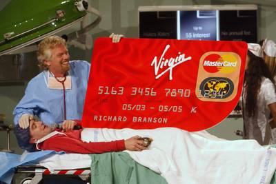 The Virgin founder 'performs surgery' on Australian comedian Jimeoin during a sketch to launch a credit card in Sydney in 2003.