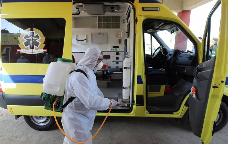 A medical worker disinfects an ambulance which transported a possible patient with coronavirus Covid-19 at fever hospital in Embaba district. EPA