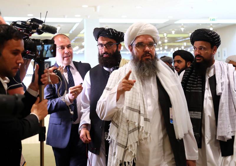 Members of Afghanistan's Taliban delegation speak to the media ahead of an agreement signing between them and US officials in Doha, Qatar. Reuters
