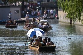 People enjoy the sunshine while punting on the River Cam in Cambridge, on September 9. AFP