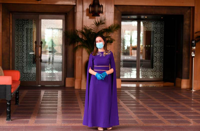 A Jumeirah Al Naseem hotel staff member waits to greet guests in Dubai as safety measures are eased. Karim Sahib / AFP