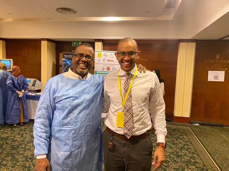 Dr Sulieman (left) with friend and colleague Dr Mohamed Eisa, Secretary-General of Sapa, at a conference in Khartoum in February. Photo: Dr Mohamed Eisa