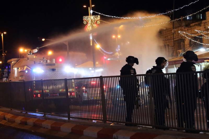 Israeli police use a water cannon to disperse Palestinian protesters from the area near the Damascus Gate to the Old City of Jerusalem on Friday, May 7. AP