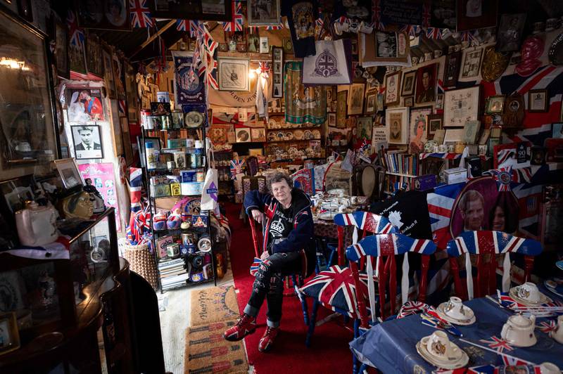 Ardent monarchist Anita Atkinson sits among her 13,283 pieces of royal memorabilia at her Weardale farm near Bishop Auckland. AFP