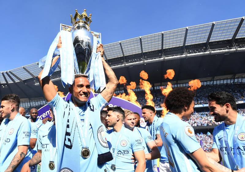 Danilo of Manchester City celebrates with The Premier League Trophy after the Premier League match between Manchester City and Huddersfield Town at Etihad Stadium in Manchester, England, on May 6, 2018. Michael Regan / Getty Images