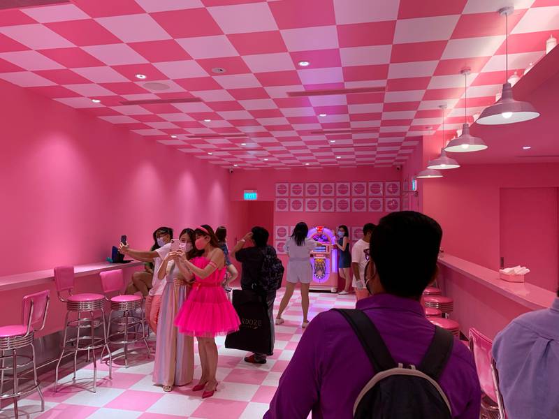 Visitors take photos in the 'Scream's Diner' at the Museum of Ice Cream in Singapore. Reuters
