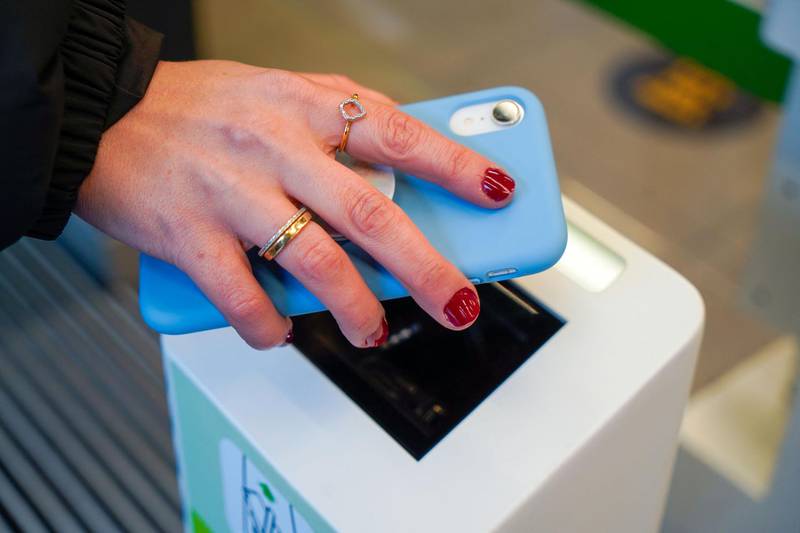 A customer scans a QR on their phone as they enter Amazon's new Amazon Fresh store in Ealing. AFP