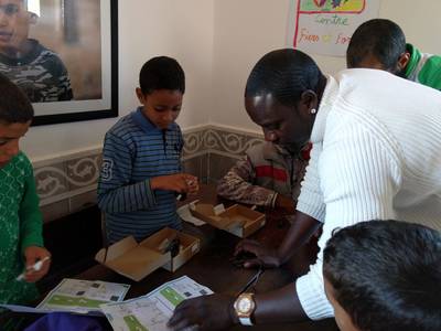 Akon helps Majid assemble one of Beacon of Hope’s light kits which will allow the Moroccon orphan to work on homework and read at night. Naser Al Wasmi / The National