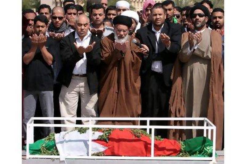 Mourners pray at the funeral of Fadel Salman Matrouk in Manama yesterday. Mr Matrook was killed on Tuesday as police tried to stop a funeral march for another Bahraini who was killed in anti-government protests on Monday.