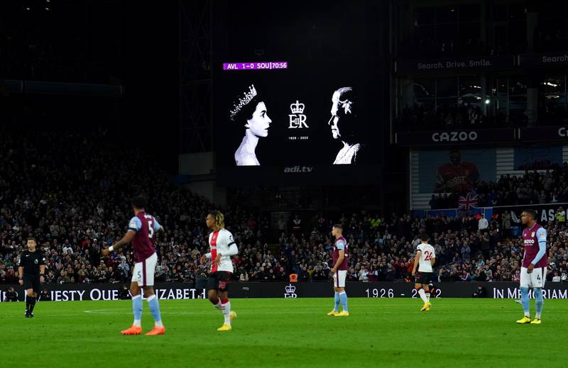 A tribute to Queen Elizabeth II is displayed on screen as fans and players observe a minute's applause in her memory in the 70th minute of the Premier League match between Aston Villa and Southampton at Villa Park on Friday September 16, 2022. PA
