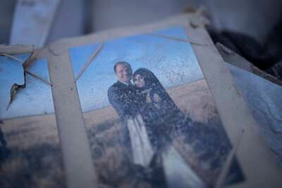 Dust covers a family photo album found in Antakya. AP Photo