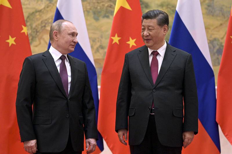 Chinese President Xi Jinping, right, and Russian President Vladimir Putin talk to each other during their meeting in Beijing, China ahead of the opening of the Winter Olympic Games. AP