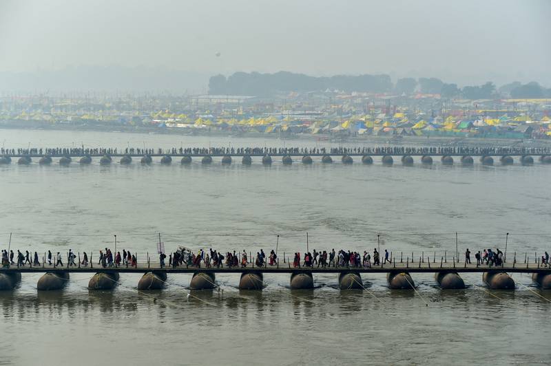 Hindus cross pontoon bridges spanning the Sangam, the confluence of the Ganges, Yamuna and Saraswati rivers, to take a holy dip to mark Mauni Amavasya, the most auspicious day, during the Magh Mela Festival in Prayagraj, India, on January 21. Reuters