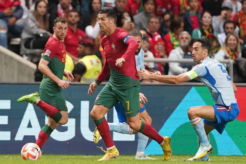 Cristiano Ronaldo on the ball under pressure from Spain midfielder Sergio Busquets. EPA