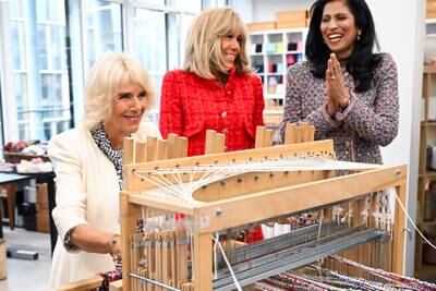 The queen, Ms Macron, and the chief executive of Chanel, Leena Nair, visit the French fashion house's 19M Campus. EPA