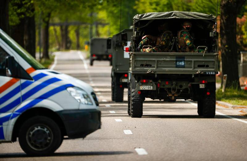 Belgian military ride in a convoy at the entrance of Hoge Kempen on May 21. A manhunt was launched after the discovery of letters, apparently by Conings, that said he did not want to live in “a society ruled by virologists” and pledging to “join the resistance”. AP Photo