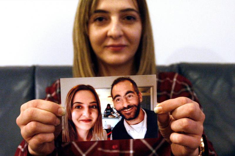 FILE - In this July 30, 2019, file photo, Aya Al-Umari, whose brother Hussein was killed in the Christchurch mosque attacks, poses, holding a photo of herself and her brother, in Christchurch, New Zealand. Al-Umari is one of more than 60 survivors and family members who this week in court will confront the white supremacist who committed the worst atrocity in New Zealandâ€™s modern history, when he slaughtered 51 worshippers at two Christchurch mosques in March 2019. The four-day sentencing starts on Monday, Aug. 24, 2020.(AP Photo/Nick Perry, File)