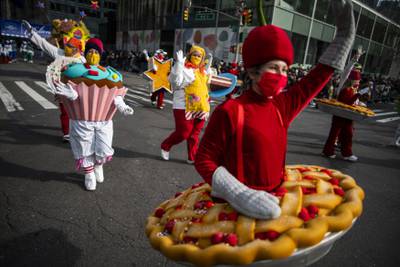People in costumes walk down Sixth Avenue during the Macy's Thanksgiving Day Parade. AP