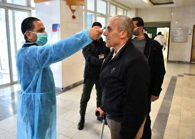 A Lebanese medic takes the temperature of a suspected coronavirus case at Rafiq Hariri University Hospital in Beirut where coronavirus COVID-19 patients are being treated.  AFP