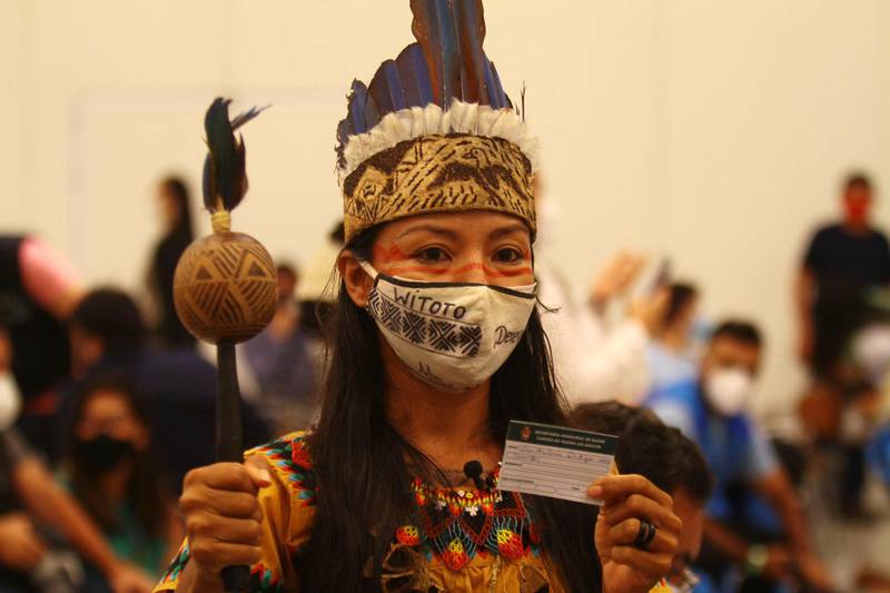 A health worker from the Witoto Indigenous group shows a card after receiving a vaccine in Manaus, Brazil. AP Photo