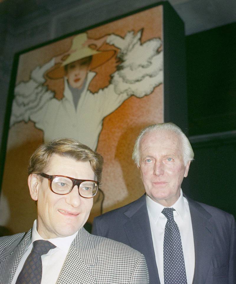 In this file photo taken on October 21, 1991 French designers Yves Saint-Laurent and Hubert de Givenchy (R) pose together in the Galliera Museum during a reception honoring Givenchy for his 40 years in fashion.  AFP