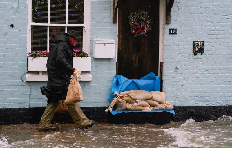 Sand bags are placed outside a property in Langstone, Hampshire. PA