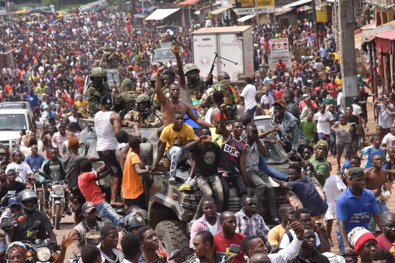 People celebrate in the streets with members of Guinea's armed forces after the arrest of Guinea's president, Alpha Conde, in a coup d'etat in Conakry, September 5, 2021.  AFP