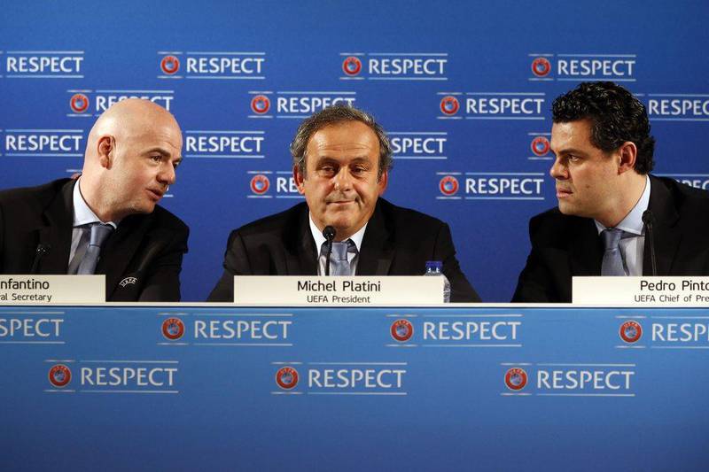 Left to right: Uefa general secretary Gianni Infantino, UEFA president Michel Platini and UEFA chief of press Pedro Pinto speak during a pres conference on the eve of the qualifying draw Euro 2016, on February 22, 2014 in Nice, southeatern France. AFP PHOTO / VALERY HACHE