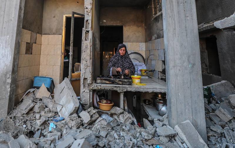 A Palestinian woman makes coffee in the kitchen of her destroyed house in Beit Hanoun, northern Gaza Strip. EPA
