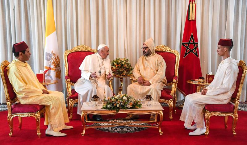 Pope Francis is received by King Mohammed VI, his son Crown Prince Moulay Hassan, right, and brother Moulay Rachid upon his arrival in Rabat. AFP