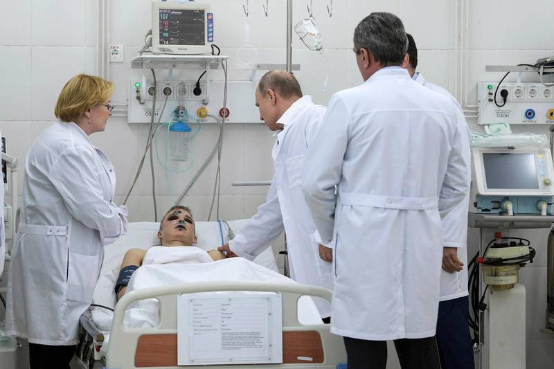 Russian President Vladimir Putin, third right, visits a boy, injured during a fire in a multi-story shopping center at a hospital in the Siberian city of Kemerovo, about 3,000 kilometers (1,900 miles) east of Moscow, Russia, Tuesday, March 27, 2018. The blaze engulfed the Winter Cherry mall in Kemerovo on Sunday, the first weekend of the school recess, trapping dozens of parents and children. Eyewitnesses reported that fire alarms were silent and many doors were locked. (Alexei Druzhinin, Sputnik, Kremlin Pool Photo via AP)