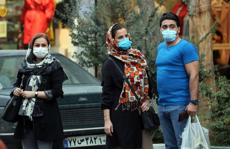epa08724489 Iranians wearing face masks wait for a taxi in a street of Tehran, Iran, 06 October 2020. According to the Iranian Health ministry, Iran reported its highest daily COVID-19 infections by announcing 4151 new infections in past 24 hours and 227 death toll as it appears that Iran is in the grip of a third wave of COVID-19 outbreak.  EPA/ABEDIN TAHERKENAREH
