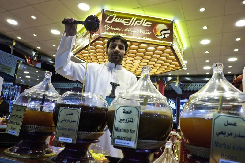 Bandar Al Shimouri works at the Yemeni Honey World in Dubai’s Global Village, which stocks honey for different types of clients ranging from students to athletes to married couples. Antonie Robertson / The National 