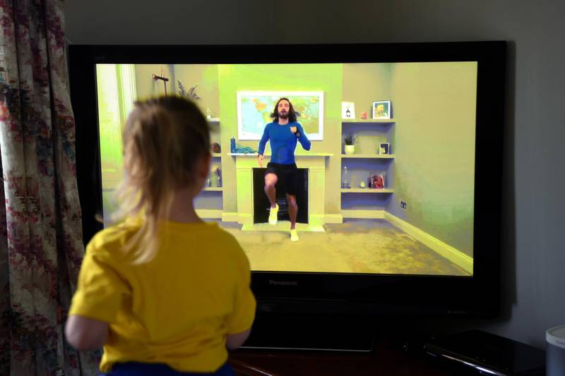 NEWCASTLE UNDER LYME, UNITED KINGDOM - MARCH 23: Four-year-old Lois Copley-Jones takes part in a live streamed broadcast of PE with fitness trainer Joe Wicks on the first day of the nationwide school closures on March 23, 2020 in Newcastle Under Lyme, United Kingdom. Coronavirus (COVID-19) pandemic has spread to at least 182 countries, claiming over 10,000 lives and infecting hundreds of thousands more. (Photo by Gareth Copley/Gareth Copley)