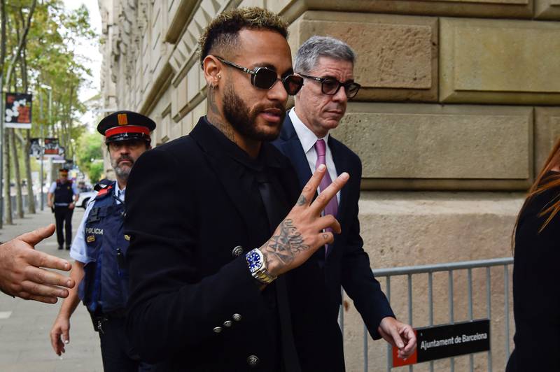 Neymar gestures as he leaves after attending the opening audience at the courthouse in Barcelona. AFP