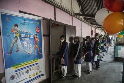 Indian teenagers wait to receive a Covid-19 vaccination at a government school in Gauhati.  India has begun vaccinating teenagers in the age group 15 to 18, as more states enforce tighter restrictions to arrest a surge of infections driven by the Omicron variant.  AP Photo