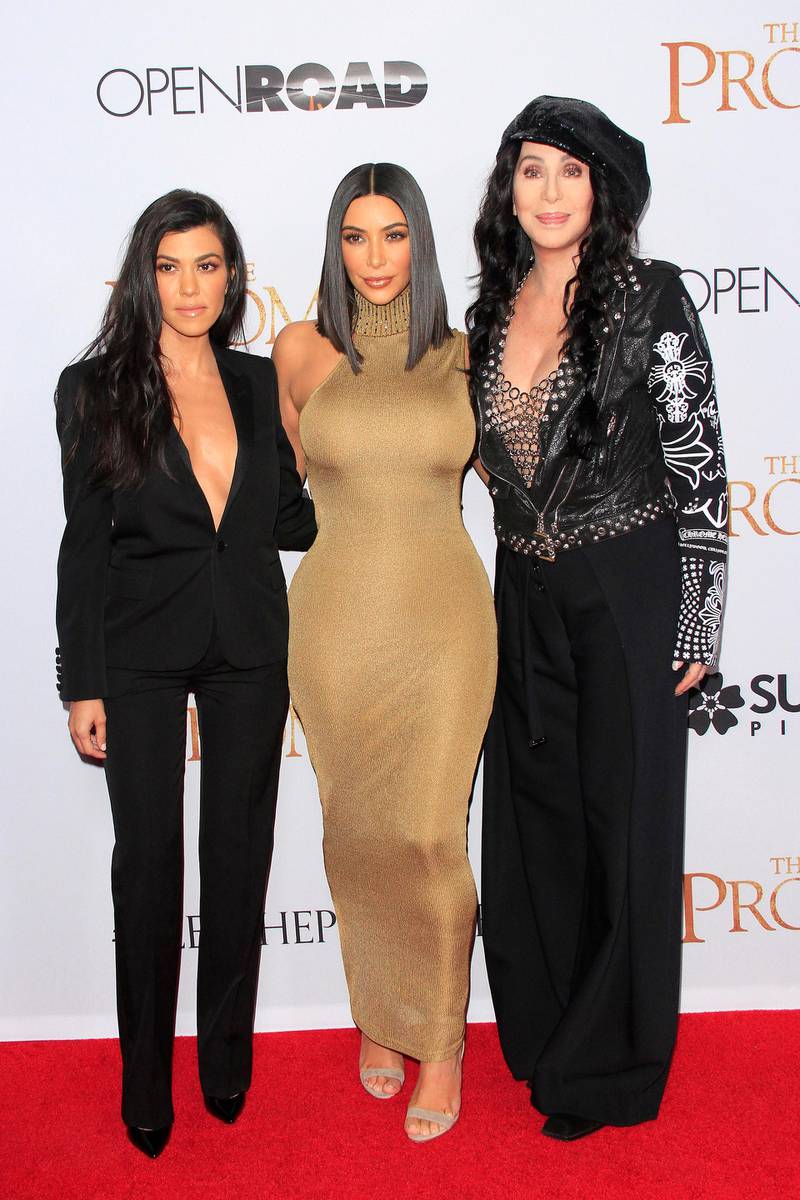 epa05905530 US television reality stars Kim Kardashian (C), Kourtney Kardashian (L) and US singer Cher arrive for the US premiere of The Promise at the TCL Chinese Theatre IMAX in Los Angeles, California, USA, 12 April 2017 (issued 13 April 2017).  EPA/NINA PROMMER