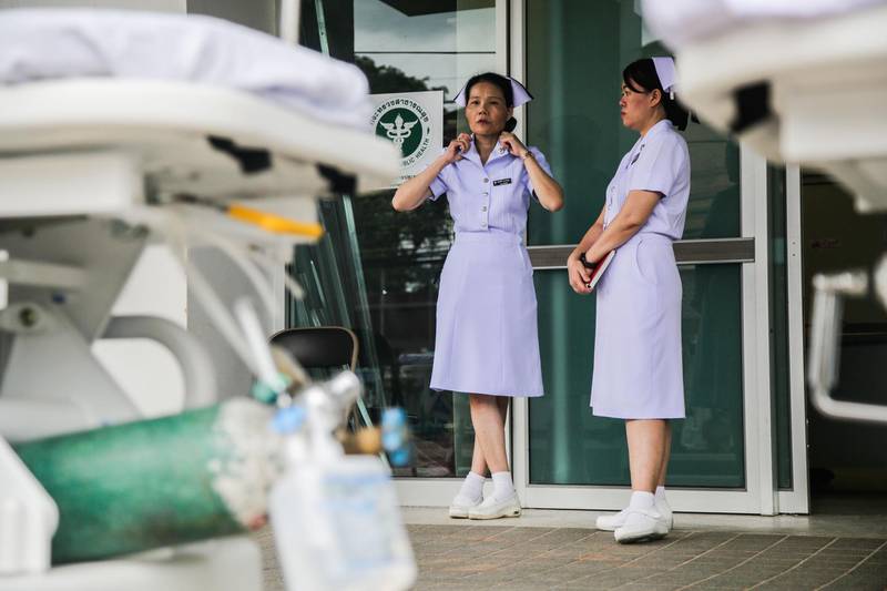 Nurses wait outside the Chaingrai Prachanukroh Hospital, where the boys will be brought upon rescue. Getty Images