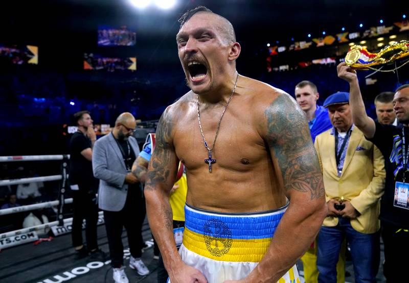 Oleksandr Usyk celebrates after retaining his world heavyweight titles. PA