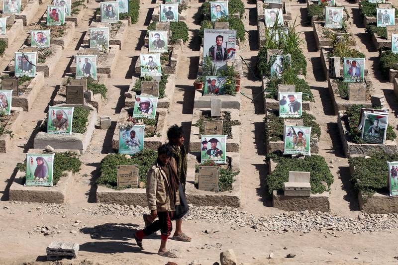 Pro-Houthi Yemenis walk past portraits on the graves of Houthi militia members allegedly killed in ongoing fighting, during the funeral of Houthi militiamen, at a cemetery in Sana'a, Yemen.  EPA