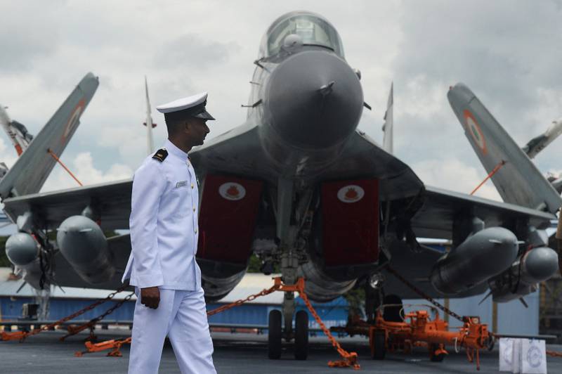 An Indian Navy officer walks past a MiG-29 fighter jet at Cochin Shipyard in Kochi, in September 2022.  AFP