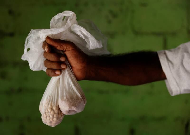 Mr Nihal, holding two small bags of chickpeas and rice, the only grain his family currently has, is now forced to cook with firewood.