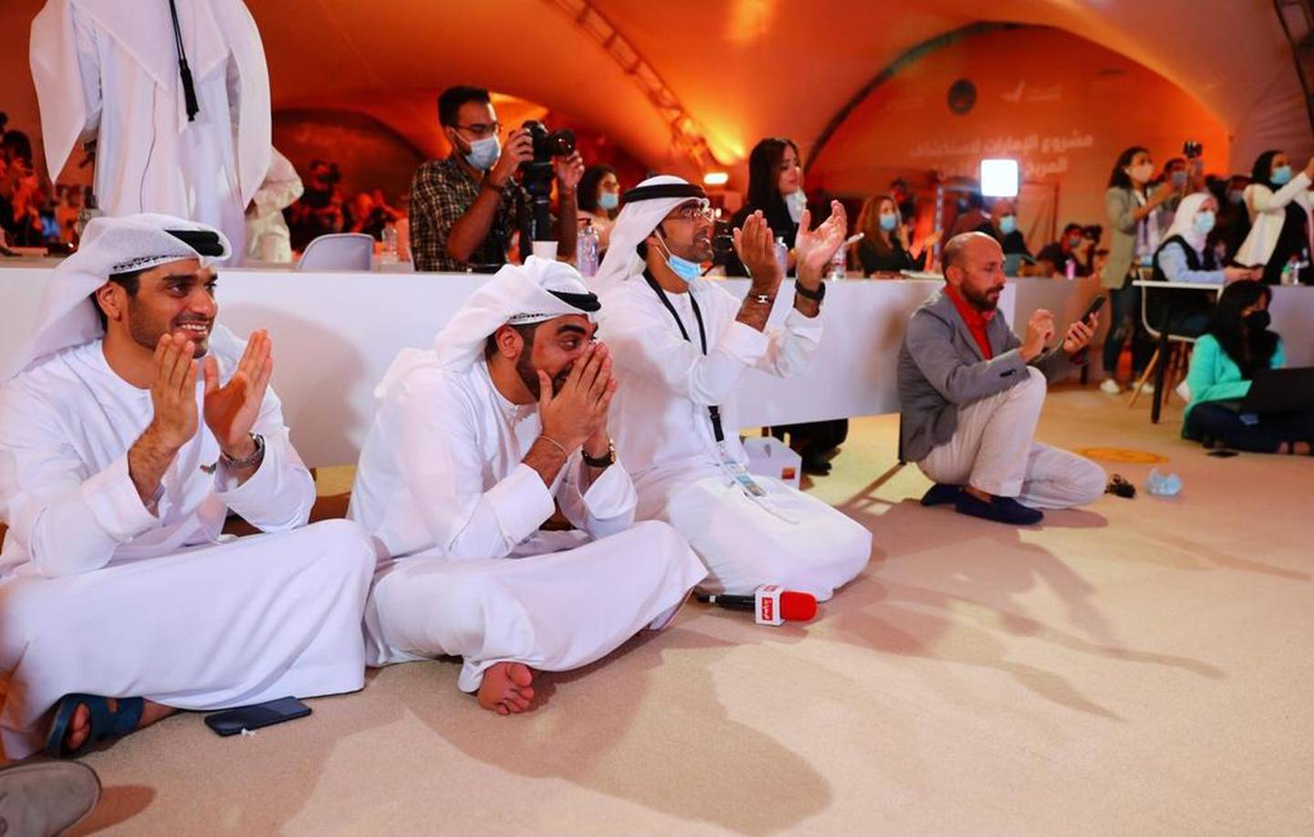 Emirati journalists at Mohammed bin Rashid Space Centre in Dubai cheer as the Hope probe is blasted into orbit just before 2am on Monday, July 20. Ahmed Jadallah / Reuters