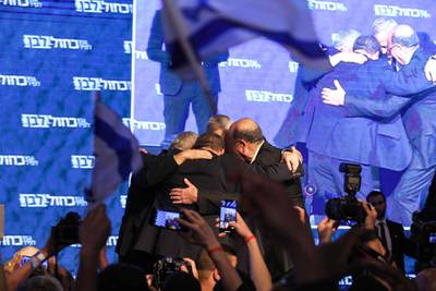Yair Lapid, Benny Gantz, Moshe Yaalon, and Gabi Ashkenazi of the Blue and White political alliance huddle together as they appear before supporters in Tel Aviv. AFP