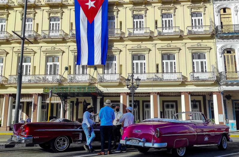 Vintage American cars parked outside Inglaterra Hotel in Havana, Cuba. AFP