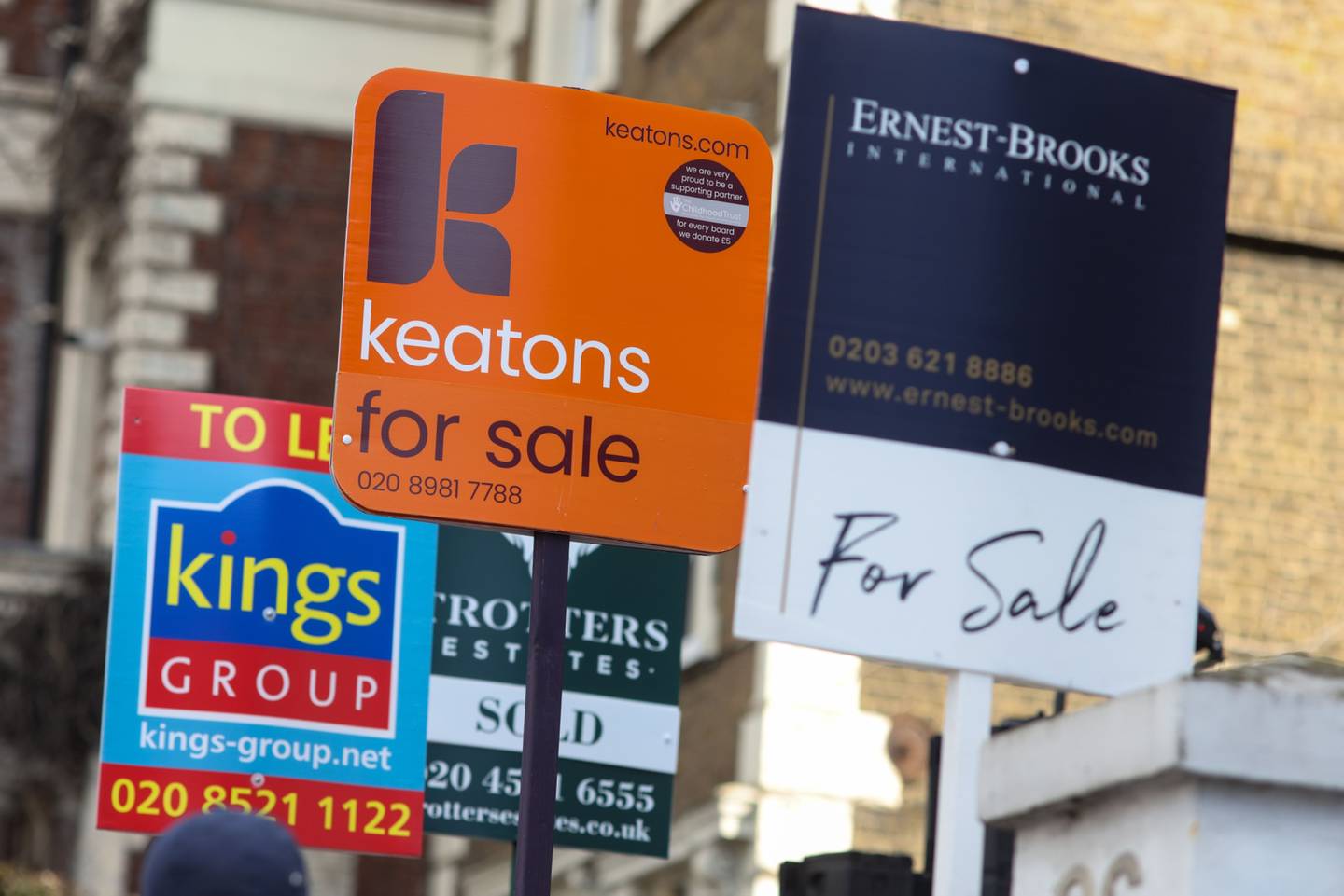 Estate agent signs outside residential properties in London, UK. Bloomberg