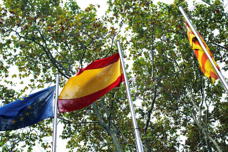 European Union (L), Spanish (C), and Catalan flags are seen one day after the banned independence referendum, in Barcelona, Spain October 2, 2017. REUTERS/Jon Nazca